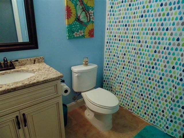 342 Duke Road Perry, GA 31069 - Photo 25 of 34 a bathroom with a granite countertop toilet and a sink