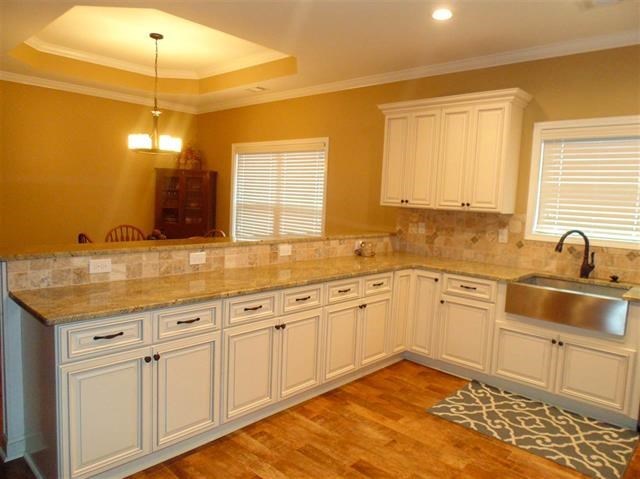 342 Duke Road Perry, GA 31069 - Photo 9 of 34 a kitchen with granite countertop white cabinets and white appliances
