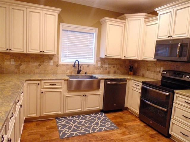 342 Duke Road Perry, GA 31069 - Photo 10 of 34 a kitchen with stainless steel appliances granite countertop a stove a sink and a microwave