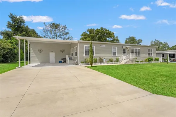 a view of house with yard outdoor seating and green space
