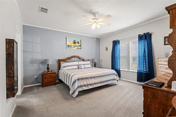 a spacious bedroom with a bed and furniture