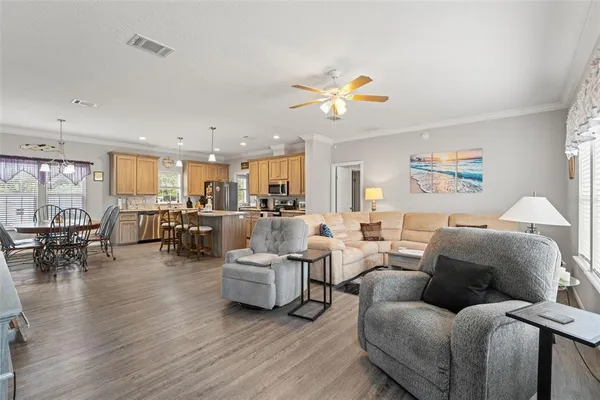a living room with furniture dining table and a chandelier