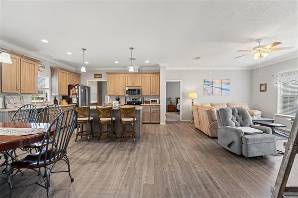 a living room with lots of furniture and kitchen view