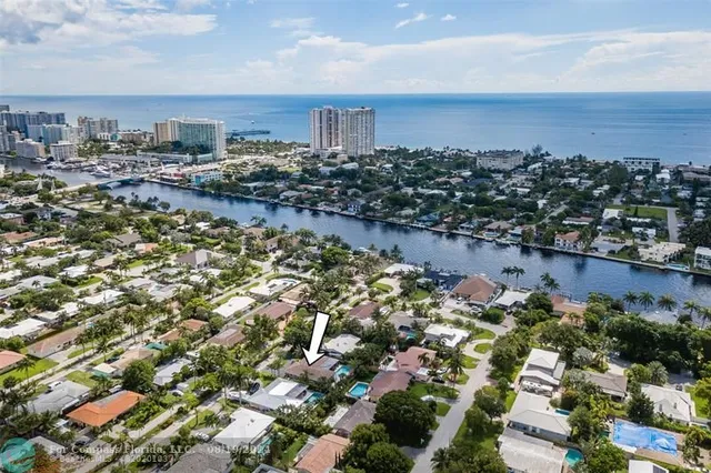 a view of a house with swimming pool and sitting area
