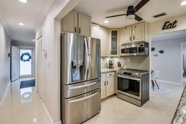 a kitchen with stainless steel appliances and white cabinets