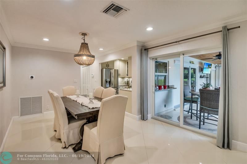 Undisclosed Address Pompano Beach, FL 33062 - Photo 21 of 63 a dining room with furniture and a chandelier