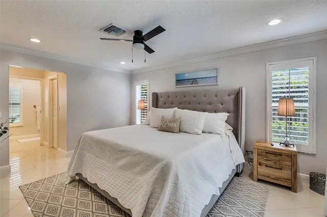 a bedroom with a large bed and a window