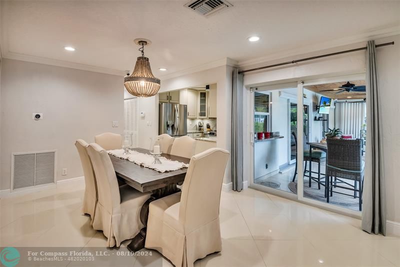 Undisclosed Address Pompano Beach, FL 33062 - Photo 26 of 63 a dining room with furniture and a chandelier