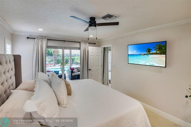 Undisclosed Address Pompano Beach, FL 33062 - Photo 28 of 63 a bedroom with a large bed and a window