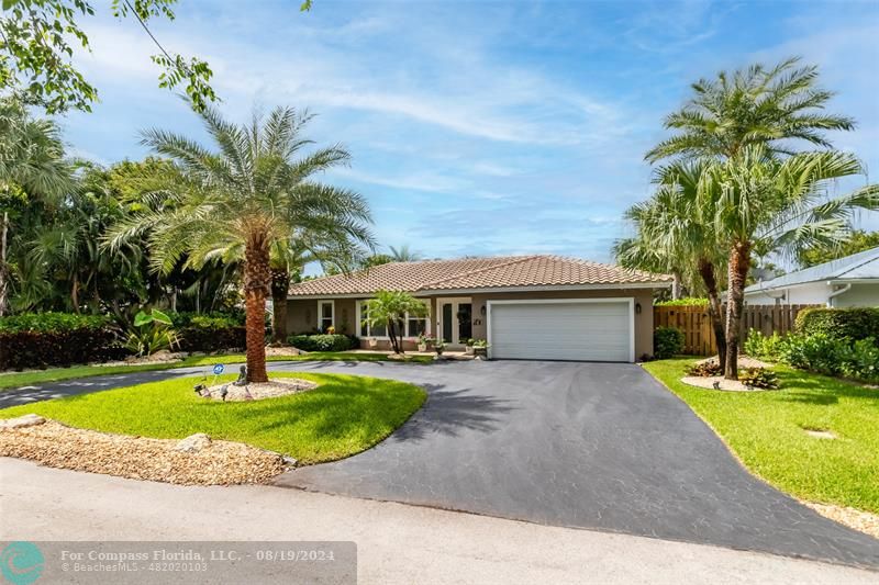 Undisclosed Address Pompano Beach, FL 33062 - Photo 3 of 63 a front view of a house with garden