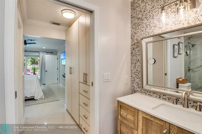 Undisclosed Address Pompano Beach, FL 33062 - Photo 33 of 63 a bathroom with a sink a mirror and a shower