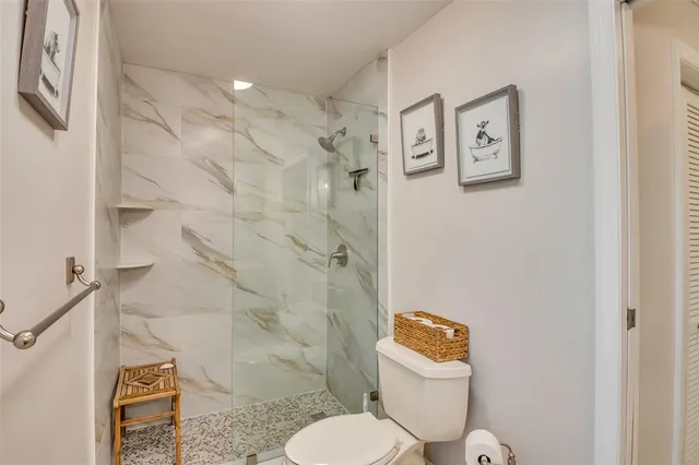 a bathroom with a double vanity sink toilet and a mirror