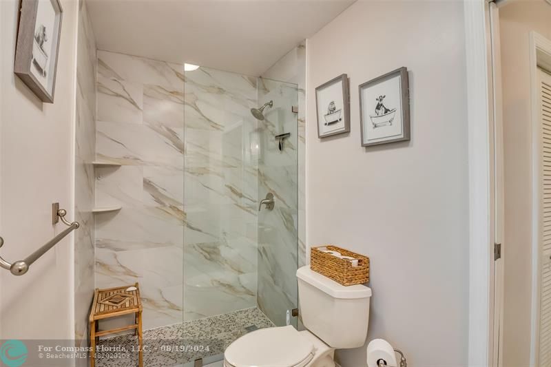 Undisclosed Address Pompano Beach, FL 33062 - Photo 35 of 63 a bathroom with a toilet and a shower curtain