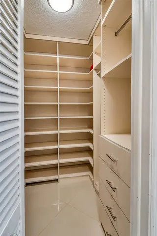 a bedroom with two beds and a large window