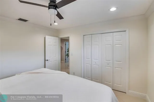 a living room with patio furniture and a potted plants