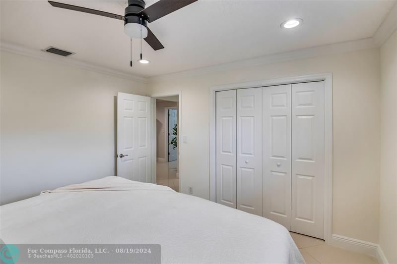 Undisclosed Address Pompano Beach, FL 33062 - Photo 38 of 63 a bedroom with a bed and a chandelier