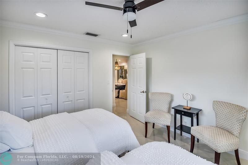 Undisclosed Address Pompano Beach, FL 33062 - Photo 40 of 63 a bedroom with a bed and a chair