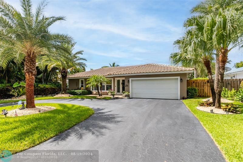 Undisclosed Address Pompano Beach, FL 33062 - Photo 4 of 63 a front view of house with yard and green space