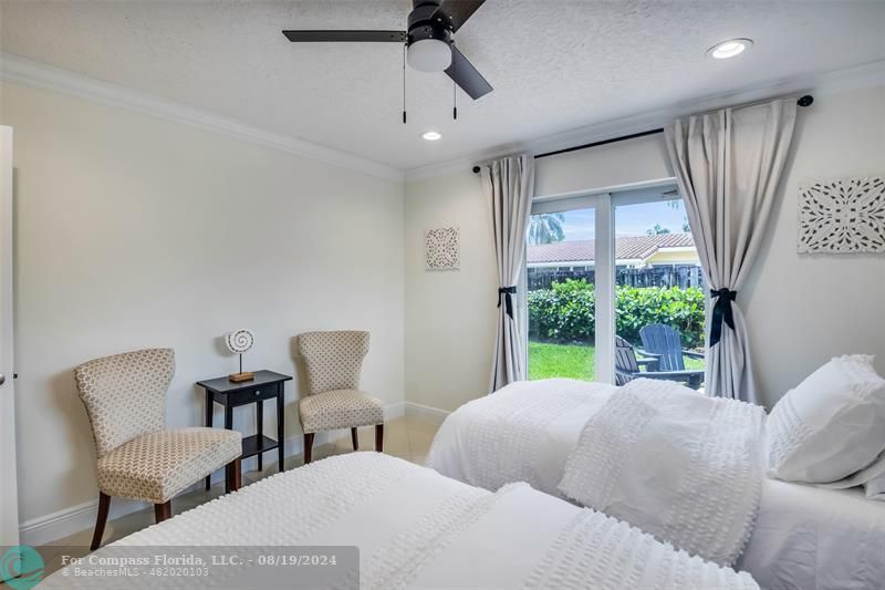 Undisclosed Address Pompano Beach, FL 33062 - Photo 42 of 63 a bedroom with two beds and a large window