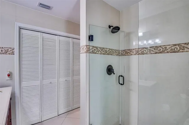 a view of a swimming pool with a patio and a yard