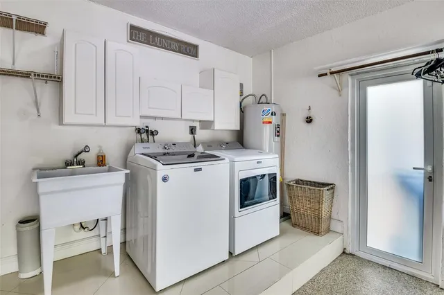 a view of a patio with table and chairs with a yard and plants