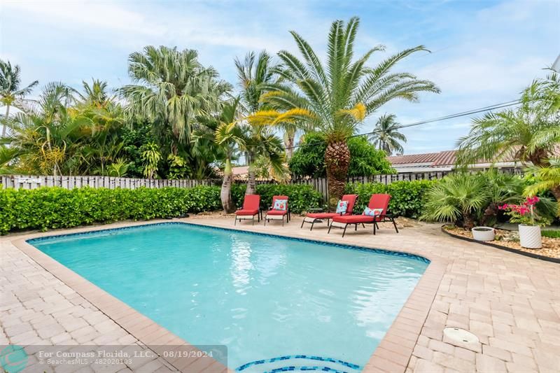 Undisclosed Address Pompano Beach, FL 33062 - Photo 51 of 63 a view of a swimming pool with a yard and plants