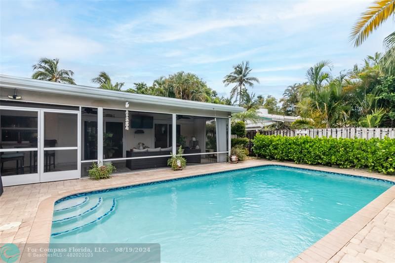 Undisclosed Address Pompano Beach, FL 33062 - Photo 52 of 63 a view of a house with a swimming pool and a yard