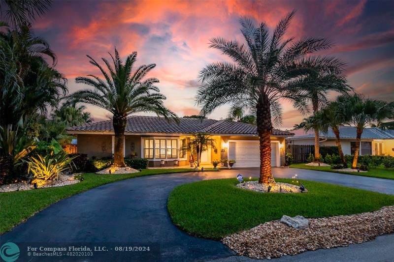 Undisclosed Address Pompano Beach, FL 33062 - Photo 63 of 63 a front view of a house with a garden and palm trees