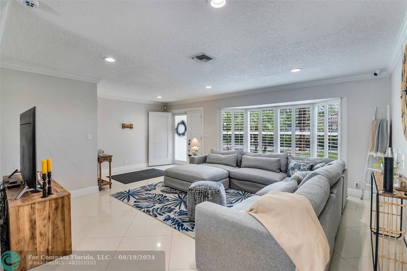 Undisclosed Address Pompano Beach, FL 33062 - Photo 8 of 63 a living room with furniture and a flat screen tv