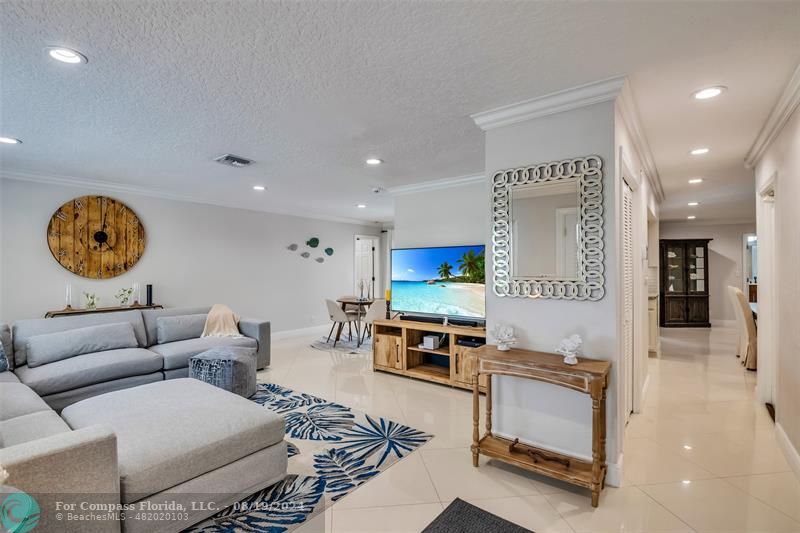 Undisclosed Address Pompano Beach, FL 33062 - Photo 10 of 63 a living room with furniture a flat screen tv and kitchen view