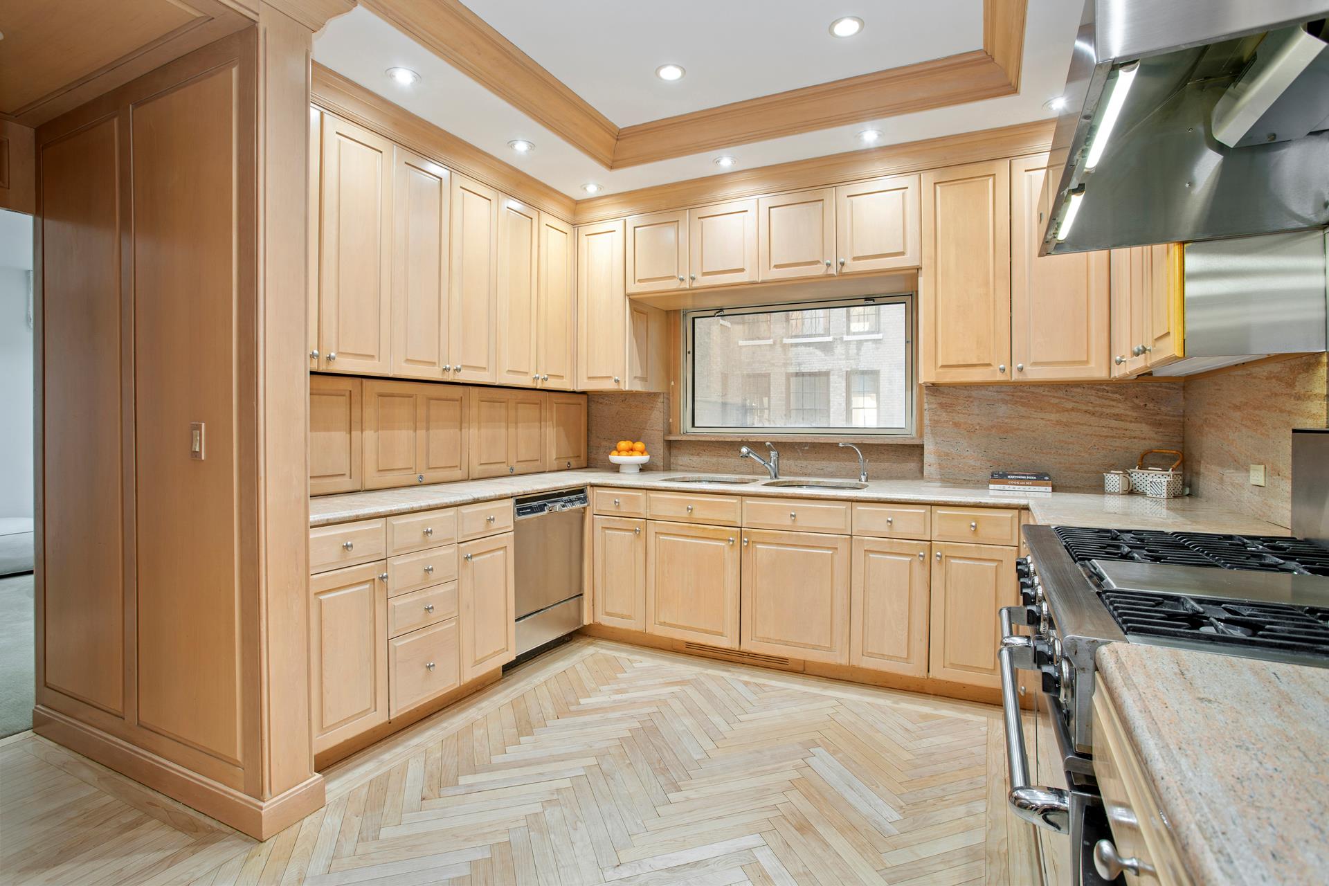 120 East End Avenue, Unit 3C Manhattan, NY 10028 - Photo 7 of 16 a kitchen with granite countertop white cabinets and white appliances