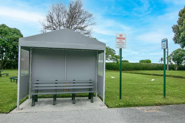 a garden with trees and wooden fence