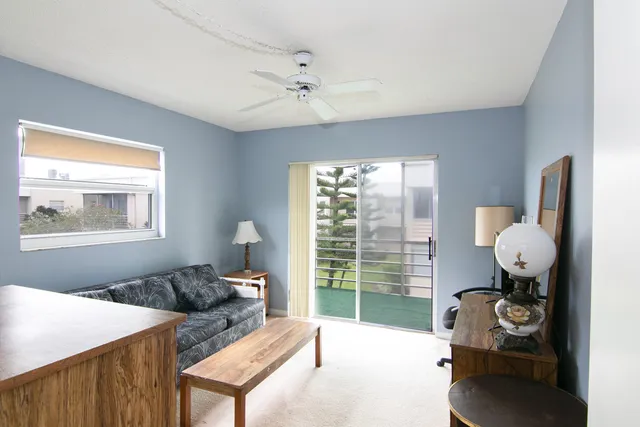 a living room with furniture and a floor to ceiling window