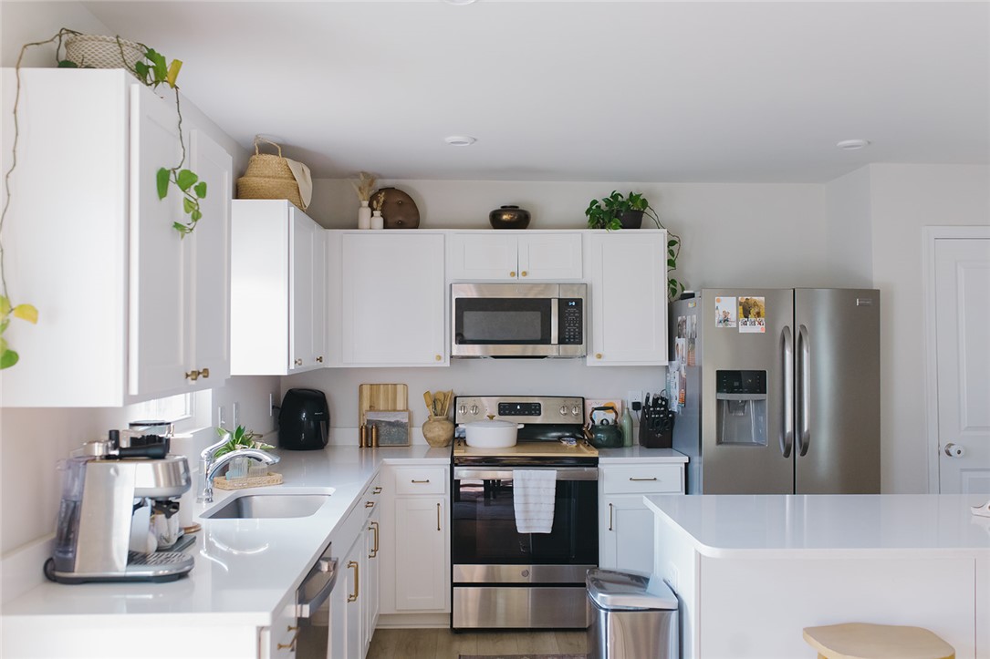 314 Callie Way Easley, SC 29642 - Photo 17 of 27 This modern kitchen features crisp white cabinetry and sleek stainless steel appliances.