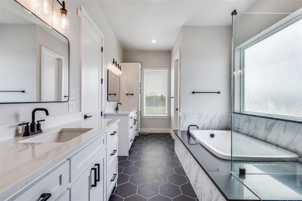 2255 County Road 377 Van Alstyne, TX 75495 - Photo 15 of 35 a bathroom with a tub a sink double vanity and a mirror