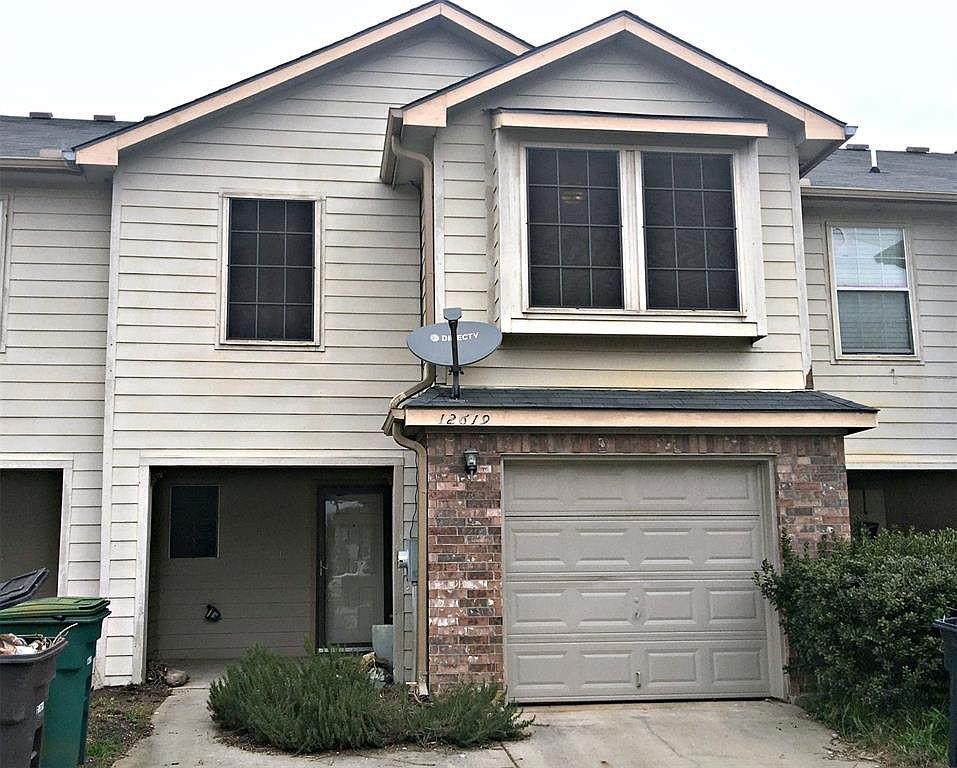 a front view of a house with a garage