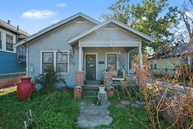 a front view of house with yard and outdoor seating