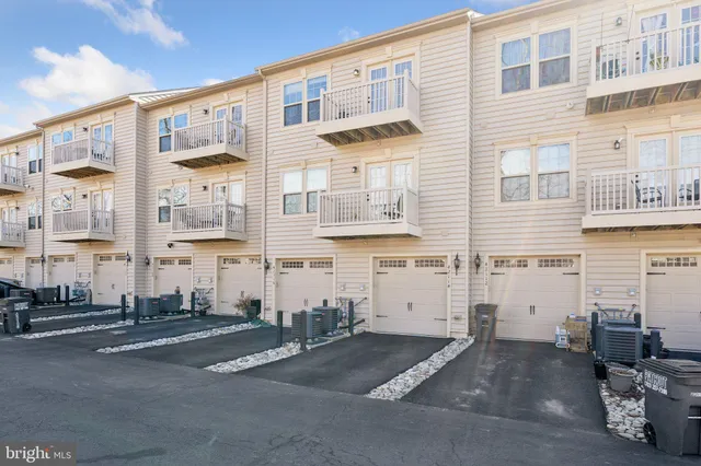 a front view of a building with glass windows and garage