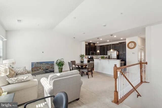 a living room with furniture and kitchen view