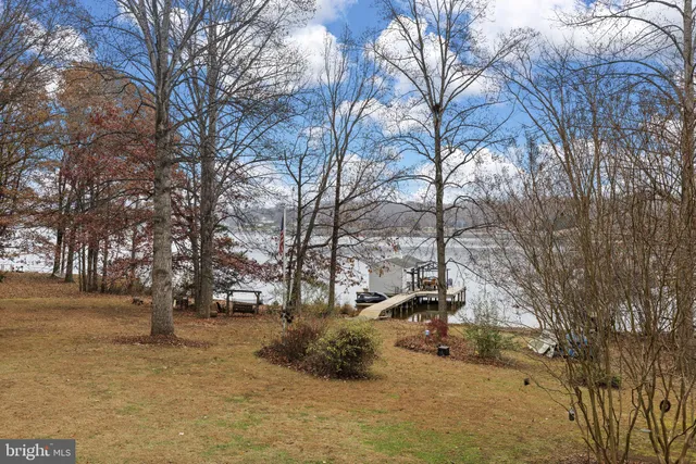 a living room with furniture kitchen view and a fireplace