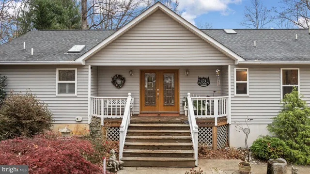 a kitchen with stainless steel appliances granite countertop a sink dishwasher and cabinets with wooden floor