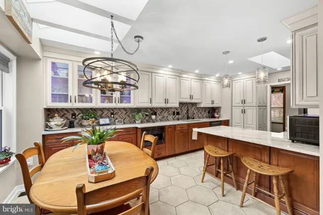 a bedroom with a large bed and a large window with the potted plants