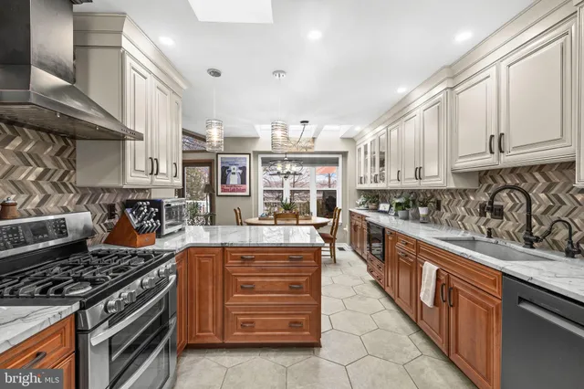 a bathroom with a granite countertop sink mirror vanity and toilet
