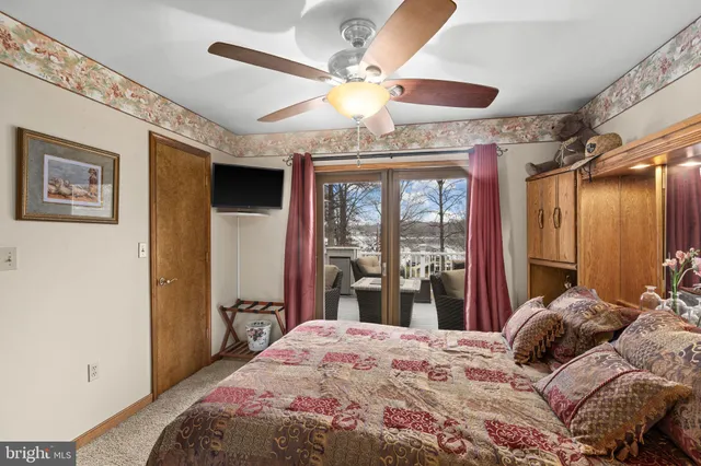 a view of a wooden deck and lake with trees in the background