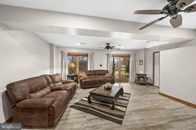 a view of a lake with couches and wooden floor