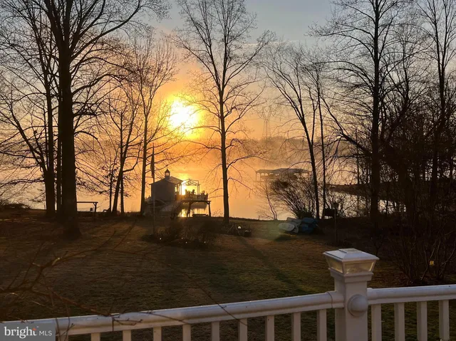 a backyard of a house with trees and snow