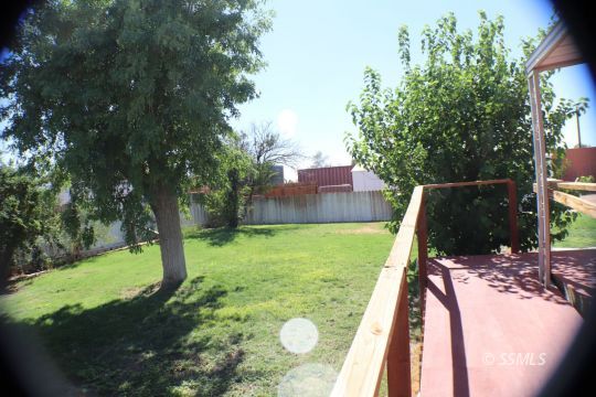 1241 South Mahan Street Ridgecrest, CA 93555 - Photo 3 of 28 a view of a backyard with swimming pool