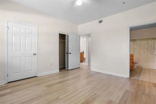 a bathroom with a granite countertop sink a toilet and a mirror