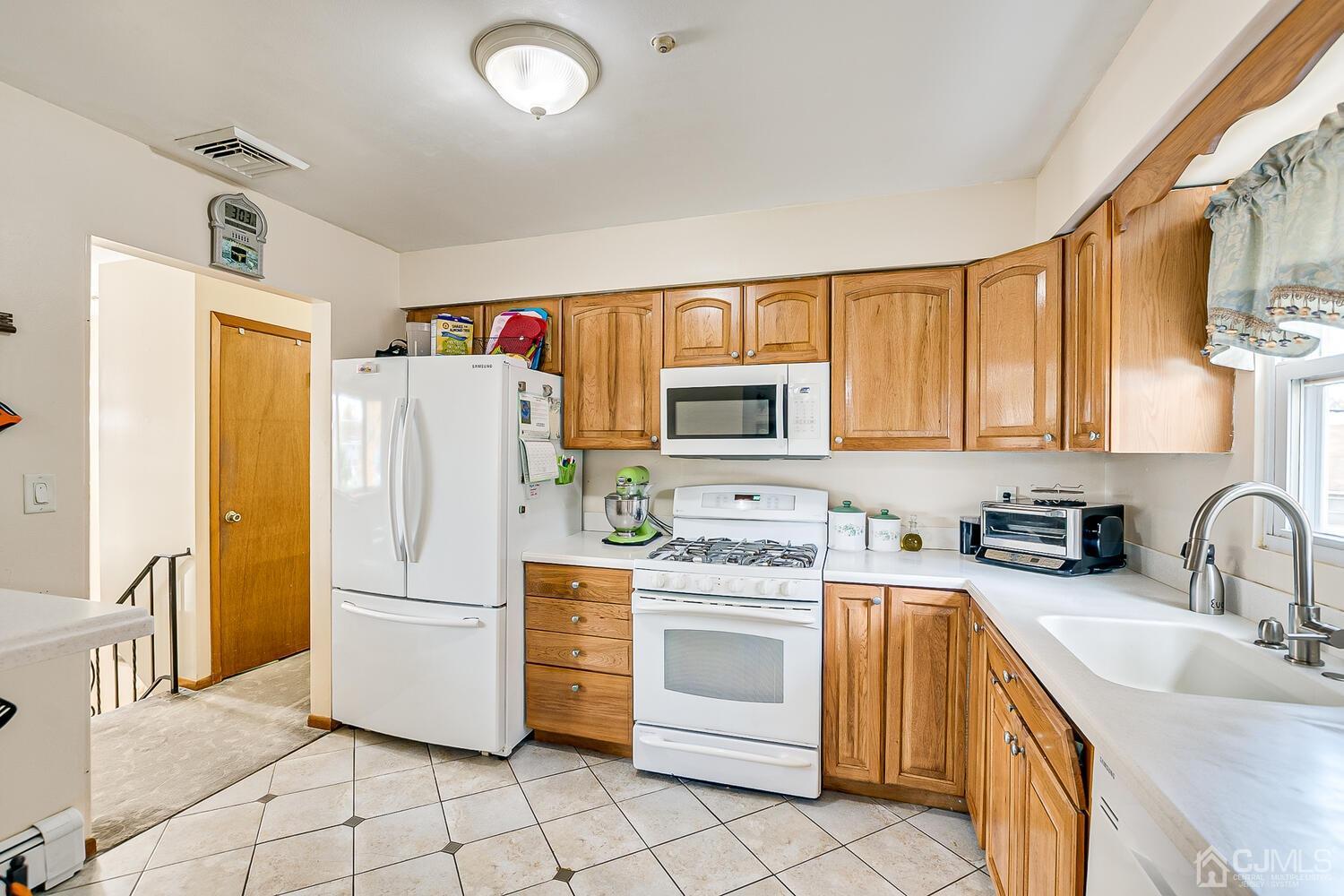 48 Brandywine Road Fords, NJ 08863 - Photo 11 of 29 a kitchen with white cabinets and white appliances