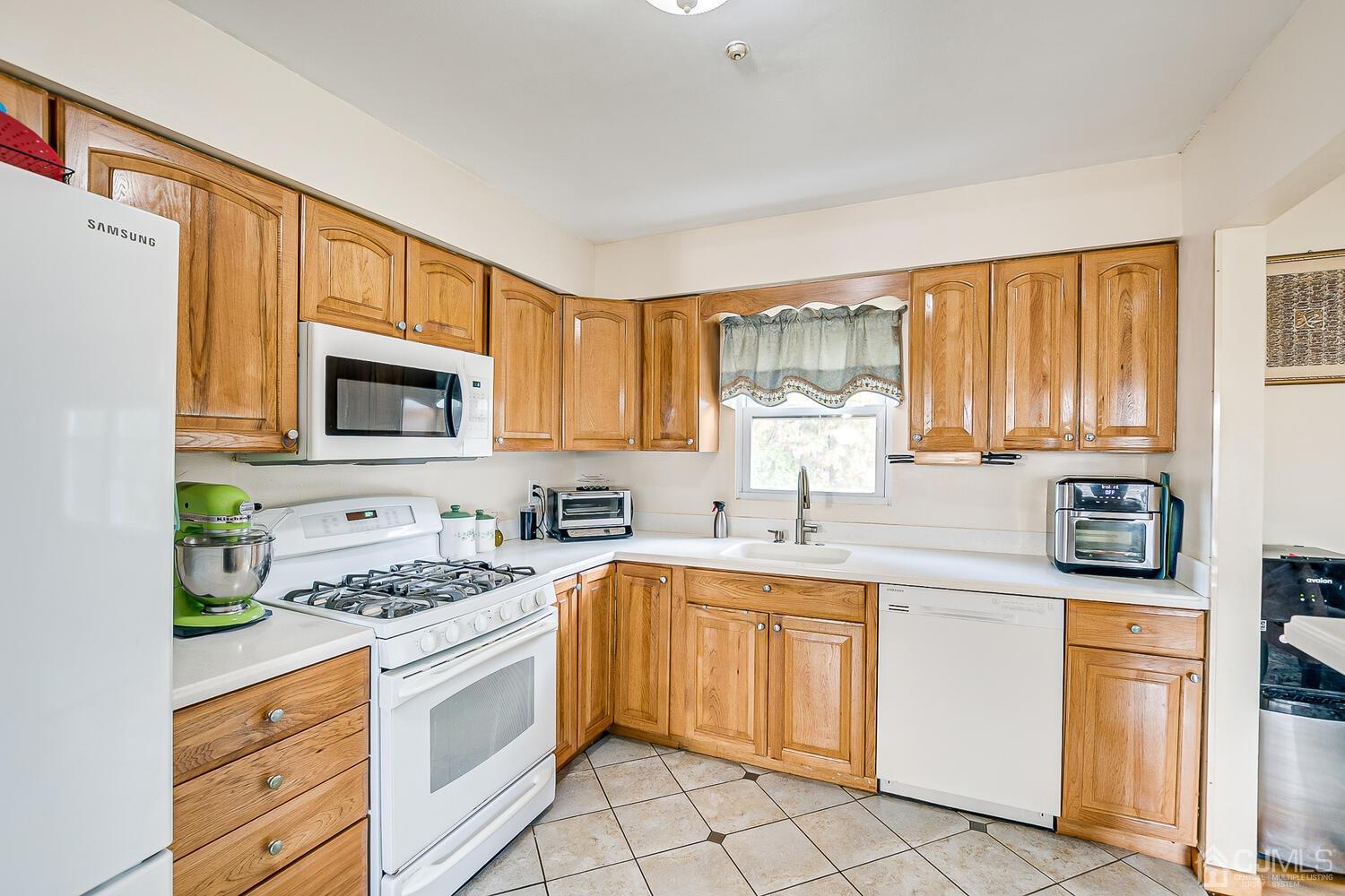 48 Brandywine Road Fords, NJ 08863 - Photo 12 of 29 a kitchen with a sink stove top oven and cabinets